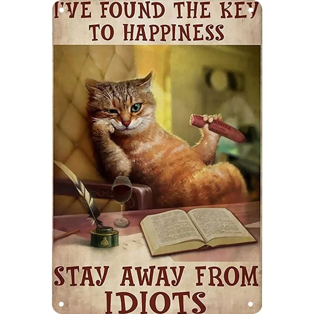 A vintage metal sign featuring a cat looking at the camera and text that reads I've found the key to happiness and Stay away 