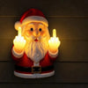 A glowing Santa Claus night light with a red suit and white beard making a middle finger gesture.