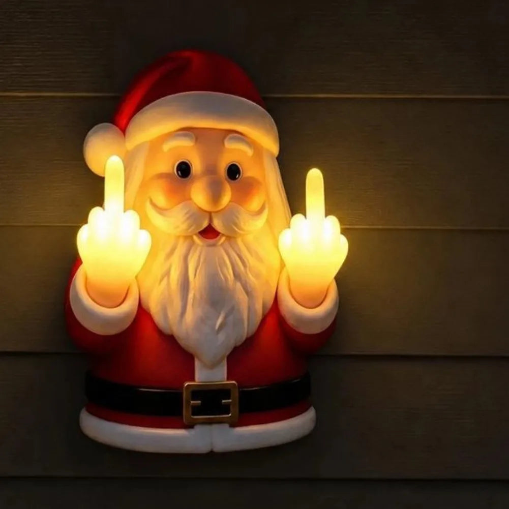 A glowing Santa Claus night light with a red suit and white beard making a middle finger gesture.