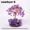 A amethyst crystal tree featuring purple crystals on a wooden branch and a dark purple base.