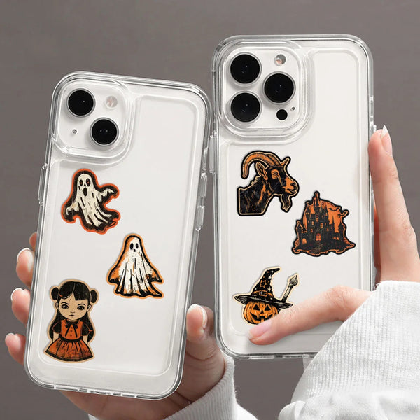 A hand holds a clear phone case featuring retro graffiti aesthetic stickers on the back.