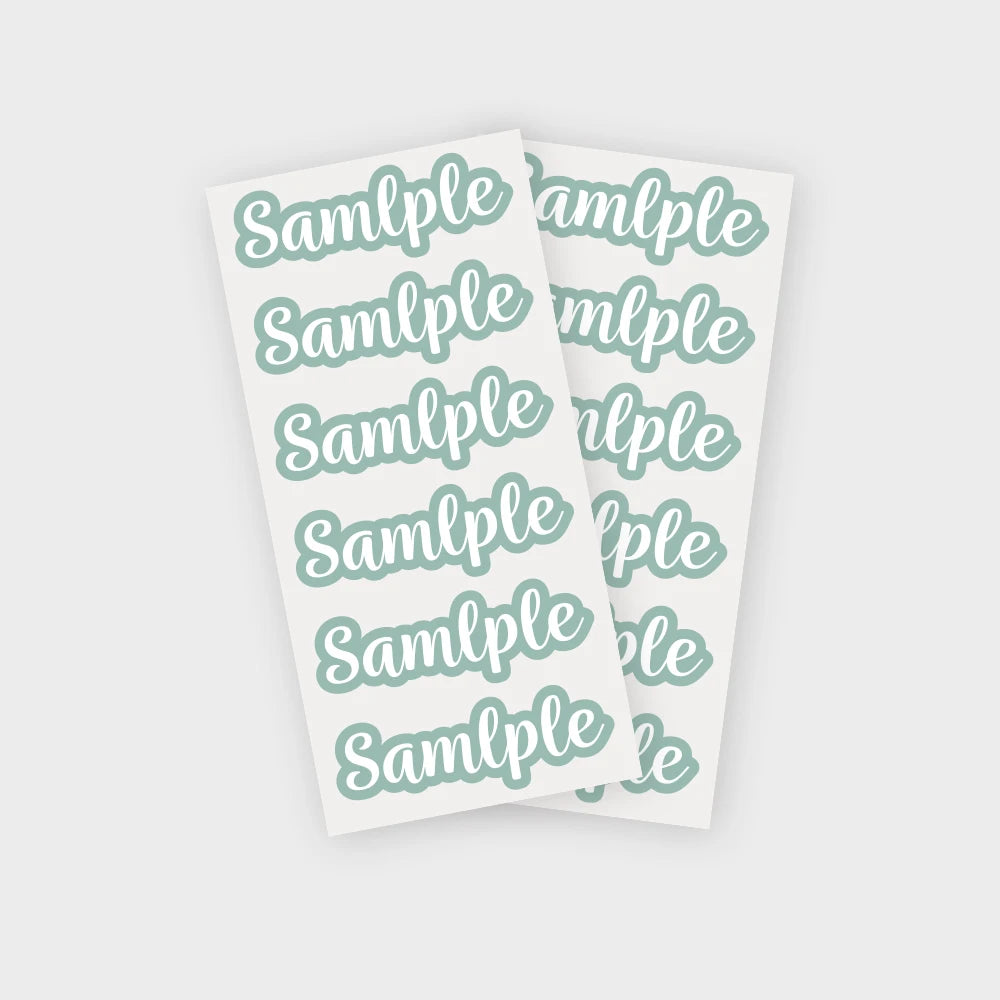 A sheet of twenty-four personalized name stickers with the text Sample for each label in a mint green color.