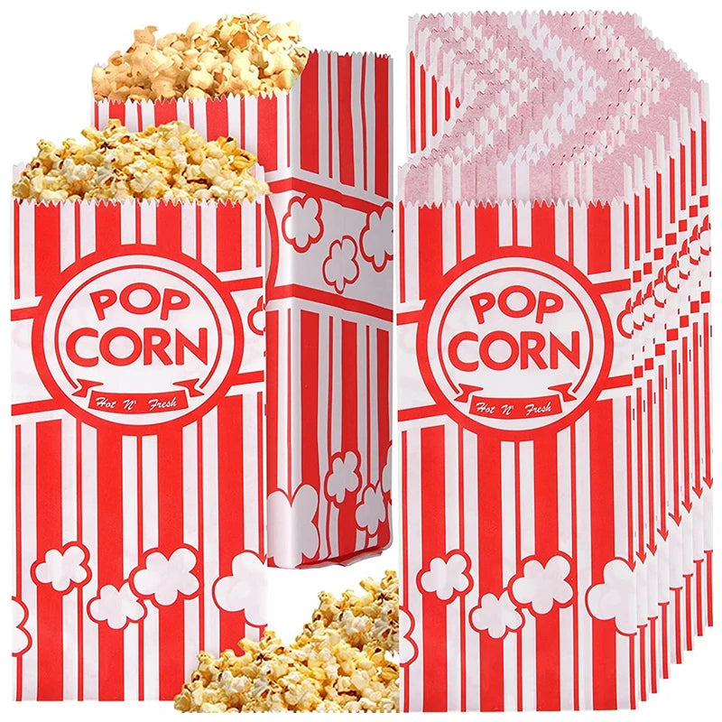 Red and white striped disposable paper popcorn bags filled with popcorn.