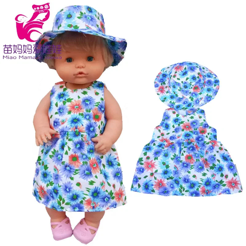 A baby doll wearing a floral print dress and matching hat.