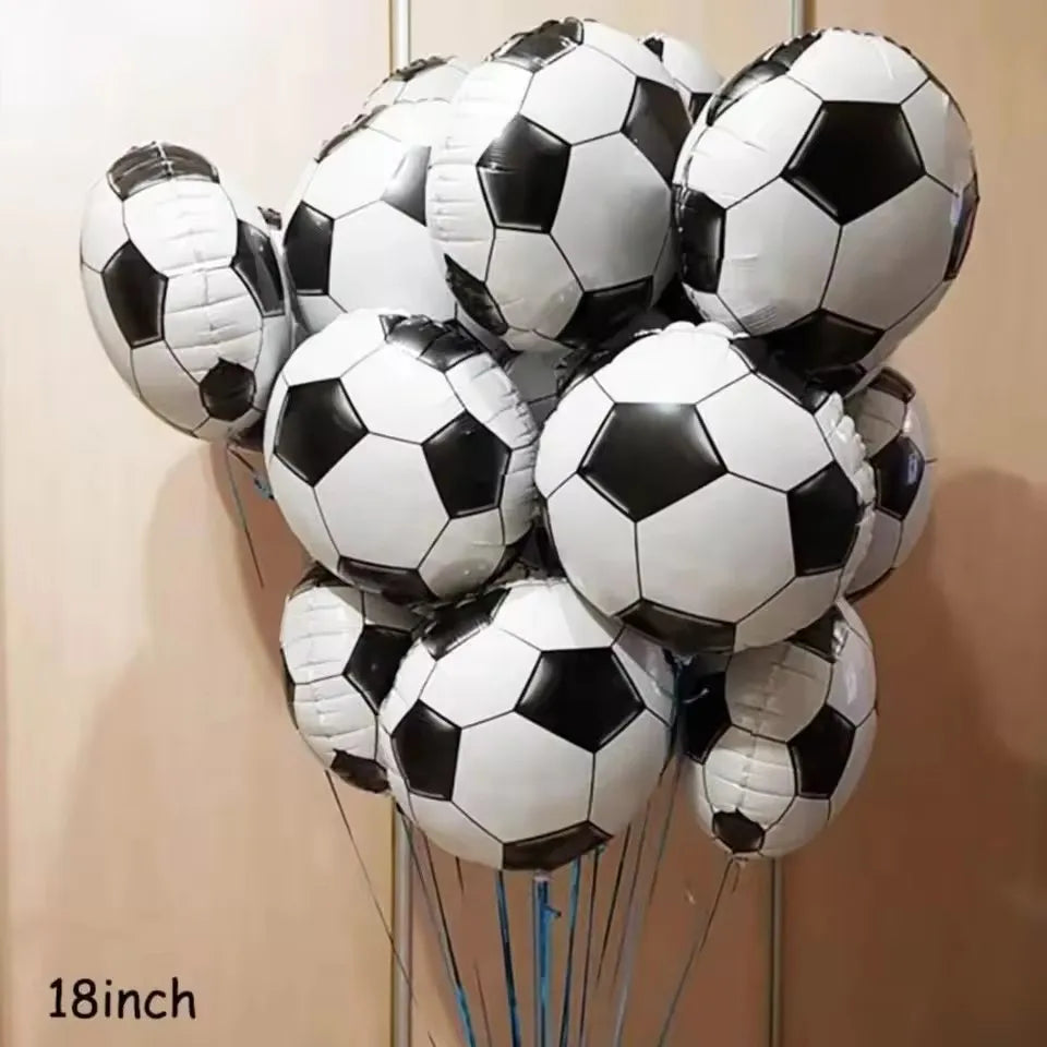 A bunch of black and white soccer ball balloons arranged in a bouquet.