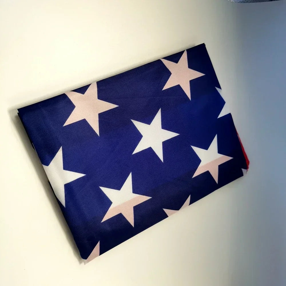 A navy blue decorative banner featuring white stars and pink accents, displayed on a light wall.