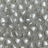 Close-up view of small, heart-shaped acrylic decoration beads in white.