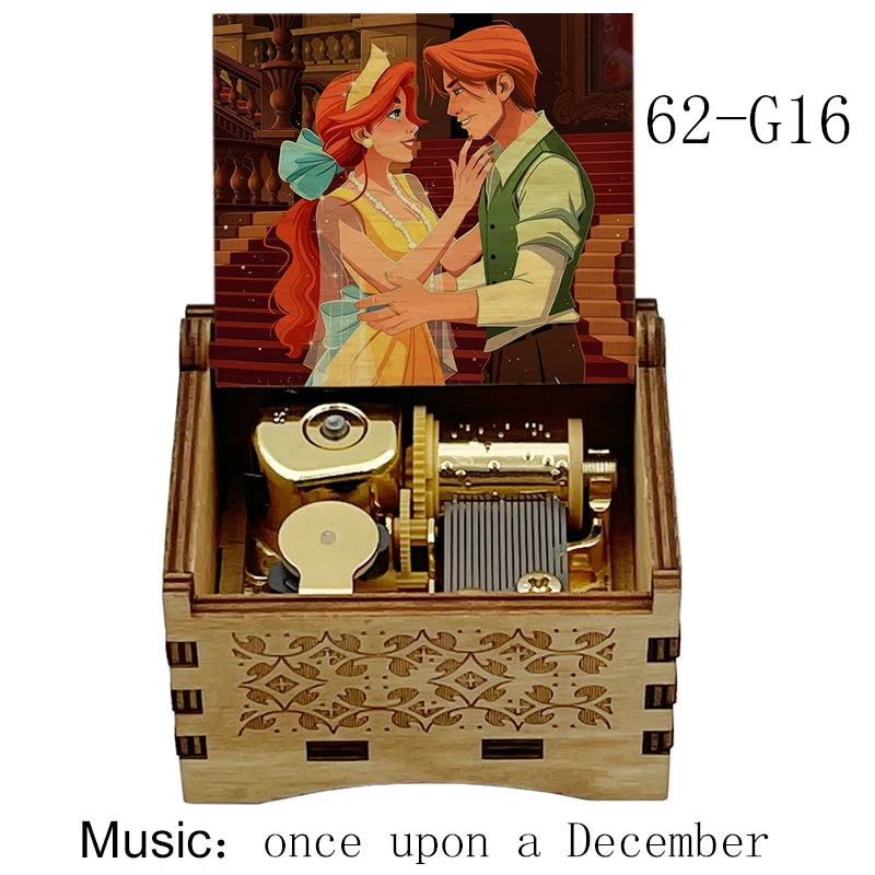 A hand-cranked wooden music box featuring an illustration of two characters, with the title Once Upon a December visible.