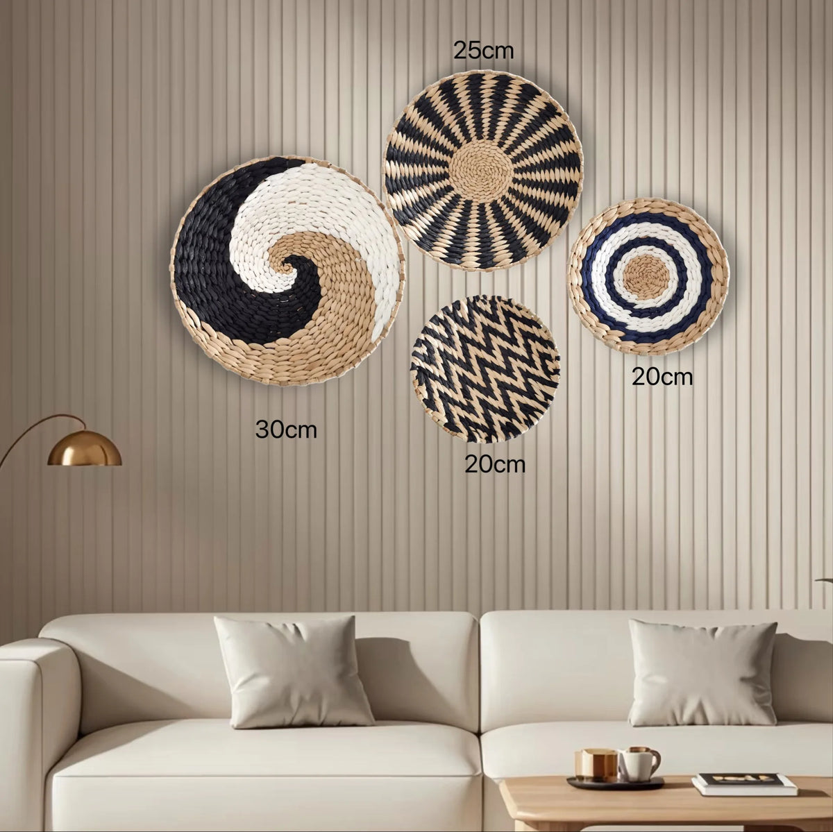 A collection of round boho straw wall hangings with geometric patterns in black, white, and natural tones displayed on a beig