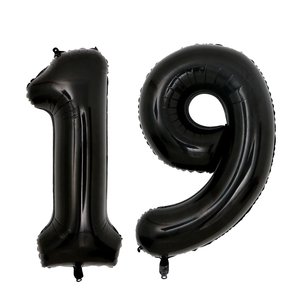 A set of two giant black foil balloons shaped like the numbers 1 and 9.