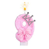 Pink bow crown number birthday candles set with a lit candle.