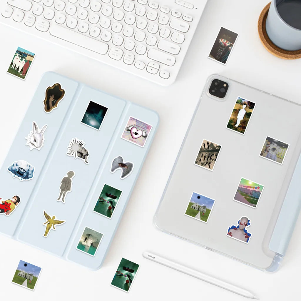 A collection of aesthetic acidic dreamcore graffiti stickers displayed on a white desk next to a laptop and a smartphone.