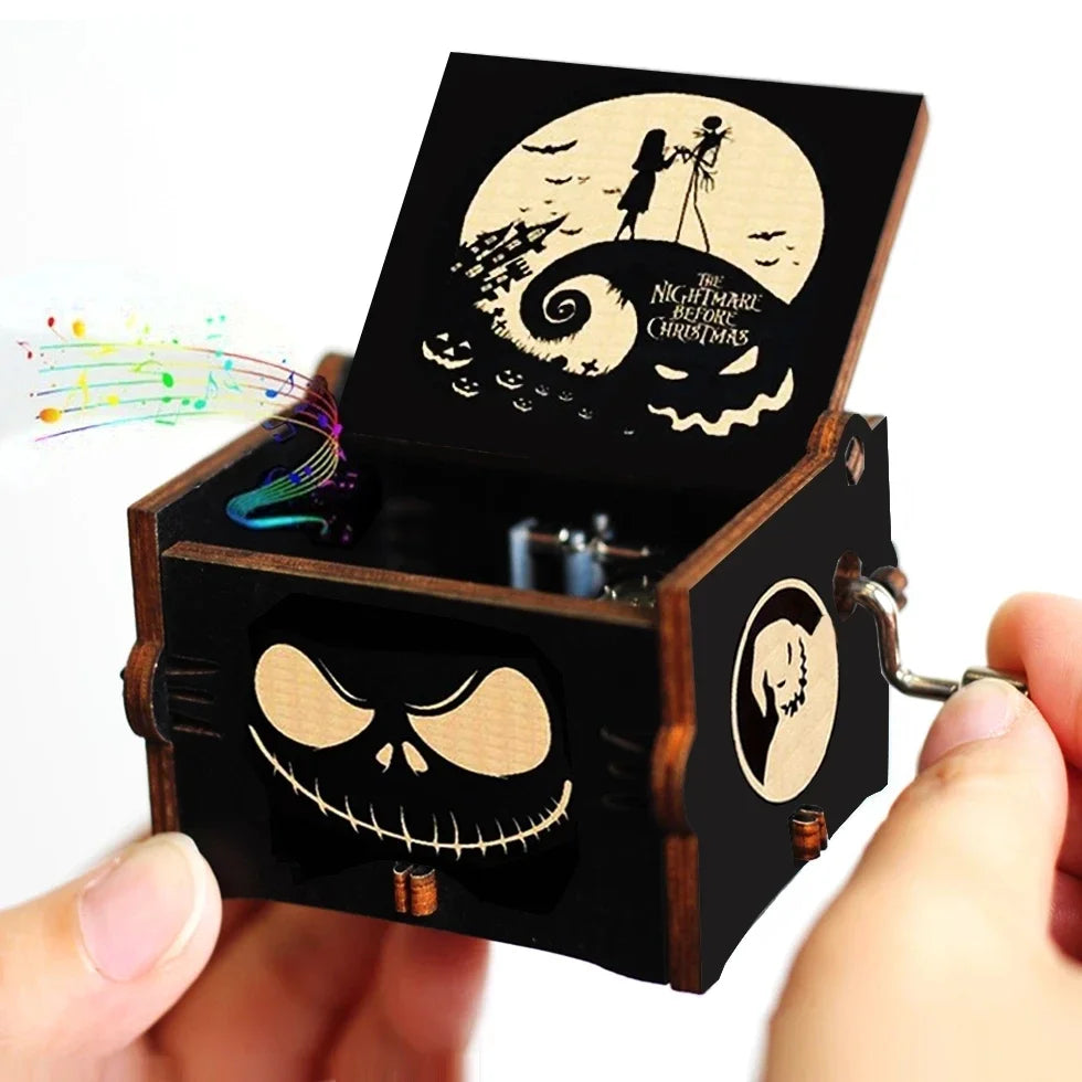 A carved wooden music box with a lid featuring a skull and bat design against a moon background.
