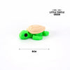 A small green turtle figurine with a light brown shell, shown from the side.