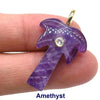 A purple amethyst crystal pendant shaped like a palm tree with a zircon charm on a gold-colored ear hook.
