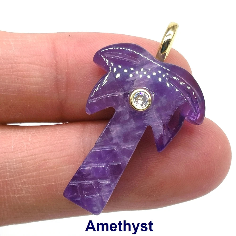 A purple amethyst crystal pendant shaped like a palm tree with a zircon charm on a gold-colored ear hook.
