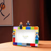 A colorful DIY building block photo frame kit featuring minifigure characters and a display area.