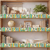 A wooden bookshelf with decorative stickers featuring green plants and colorful books on multiple shelves.