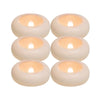 Four round waterproof floating LED candles with a warm white glow