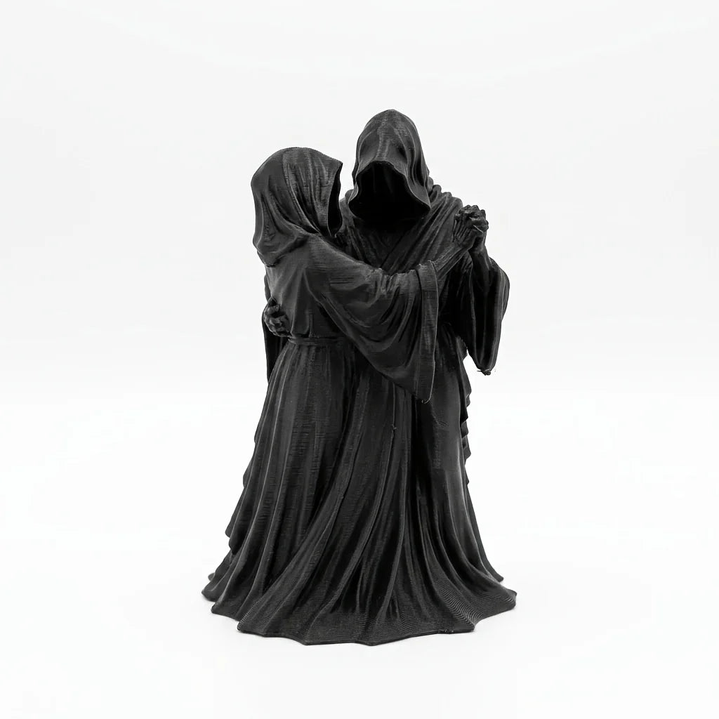 A dark romantic sculpture depicting a couple in hooded cloaks.
