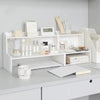 A white two-layer desktop organizer shelf displaying various skincare and stationery items.