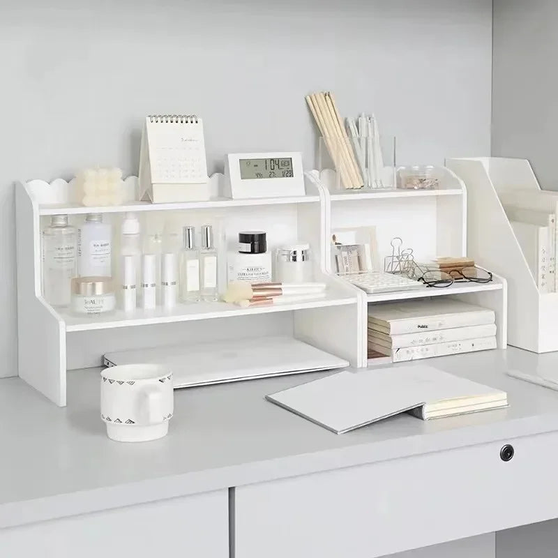 A white two-layer desktop organizer shelf displaying various skincare and stationery items.