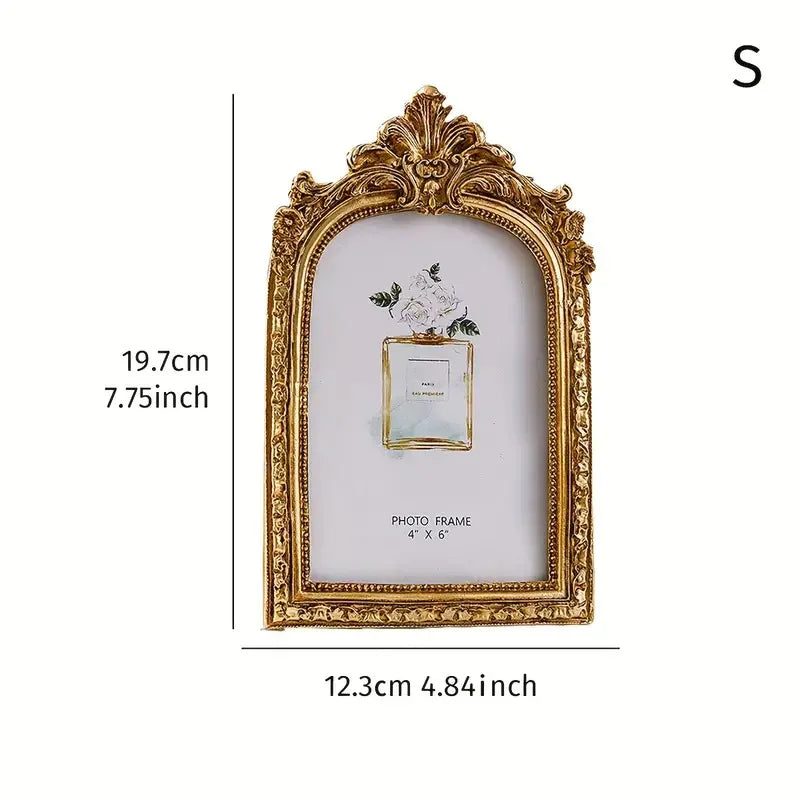 Gold-framed vintage resin photo frame with a floral arrangement inside