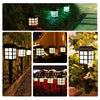 A collection of solar pathway lights illuminating a garden path and foliage at dusk.