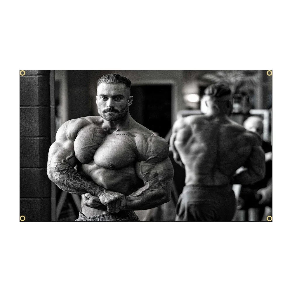 A muscular man posing with his arms flexed in a gym setting.
