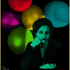 A vibrant poster featuring a woman's face surrounded by glowing colored spheres on a black background.