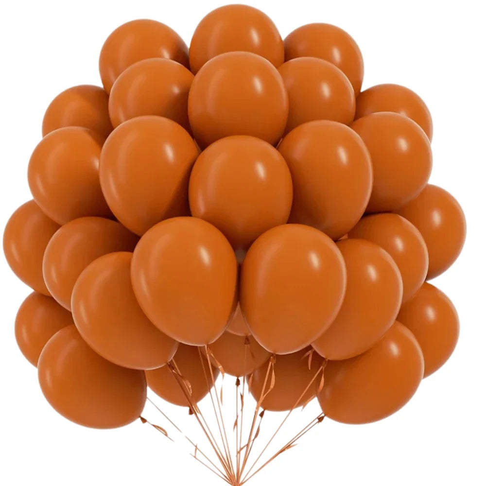 A bunch of round orange latex balloons tied together with thin gold strings.