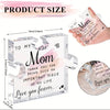 A clear acrylic puzzle-shaped plaque with engraved text for a mother, shown next to a hand.