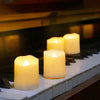 Several glowing white LED tea light candles are placed on a piano keyboard with a dark background.
