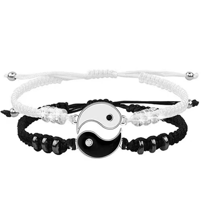 A set of braided white and black Tai Chi Yin-Yang bracelets for wrist wear.