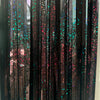 A vertical display of metallic tinsel foil fringe curtain backdrop featuring iridescent pink and blue glitter accents.