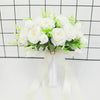Elegant white silk rose bridal bouquet with green filler flowers tied with a sheer ribbon