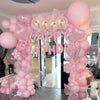 Pink marble birthday balloon decoration set featuring balloons and a banner