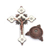 Antique-style crucifix figurine with a cross and a decorative stand.