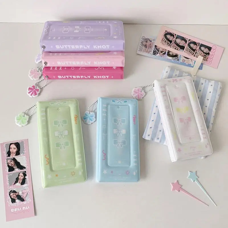 Colección de álbumes y accesorios para cabina de fotos en tonos rosa pastel y verde.