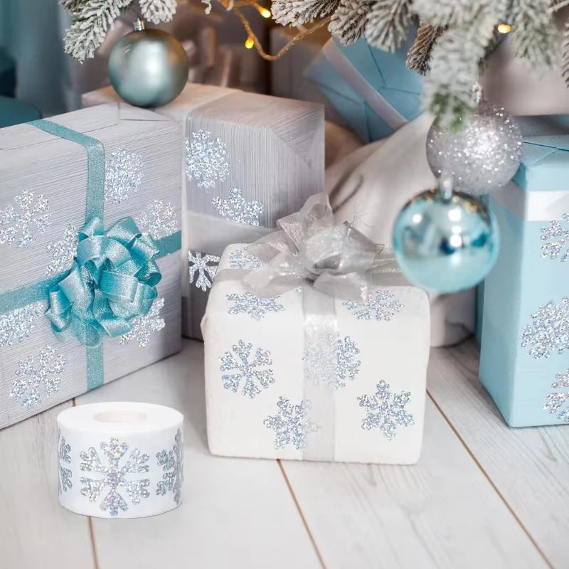 White and blue gift boxes decorated with snowflake patterns and wrapped in festive silver ribbon, set against a snowy holiday