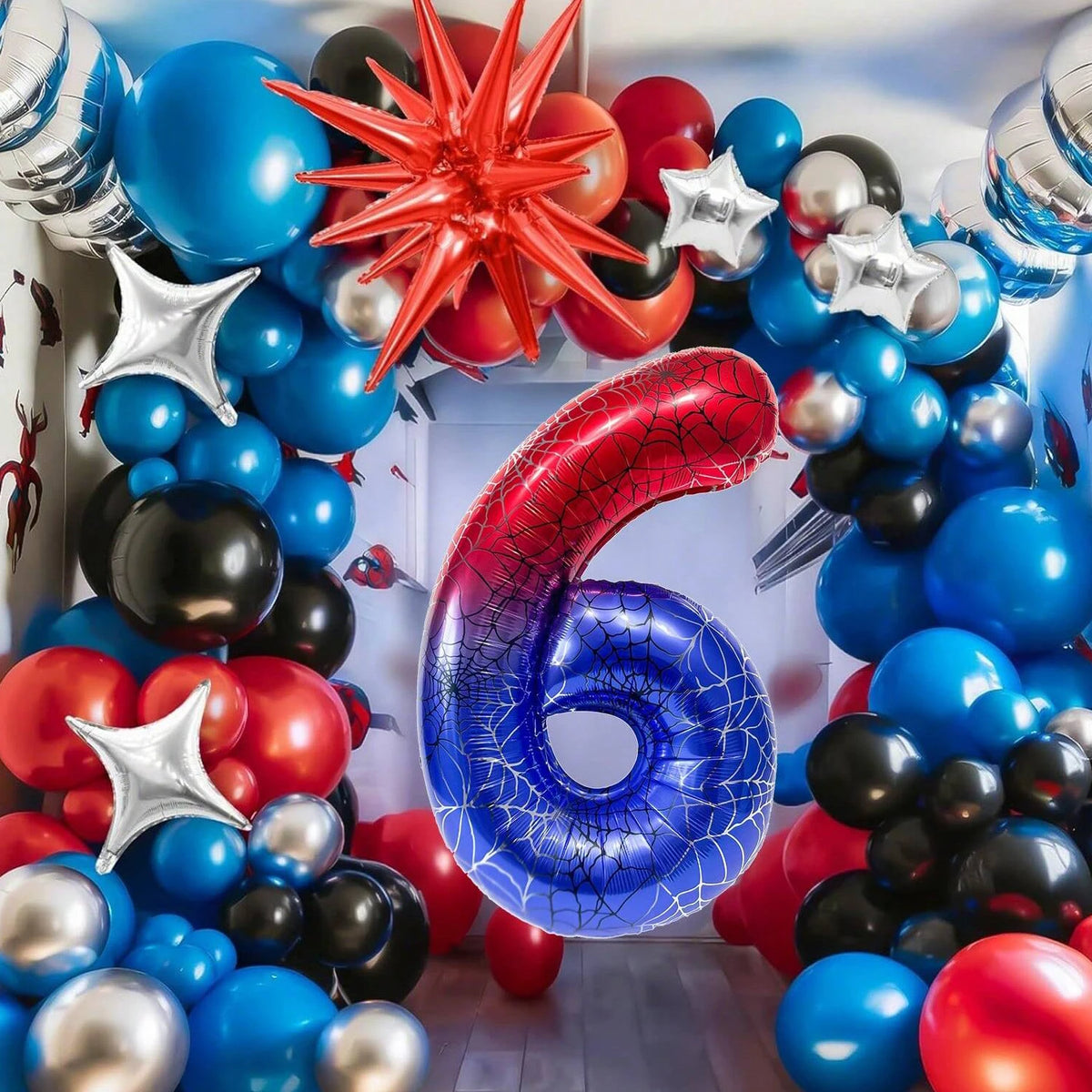 A cluster of red, blue, and black foil balloons shaped like the number six and star decorations for a party.