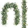 A long, lush garland of green eucalyptus leaves and small white flowers used for decoration.