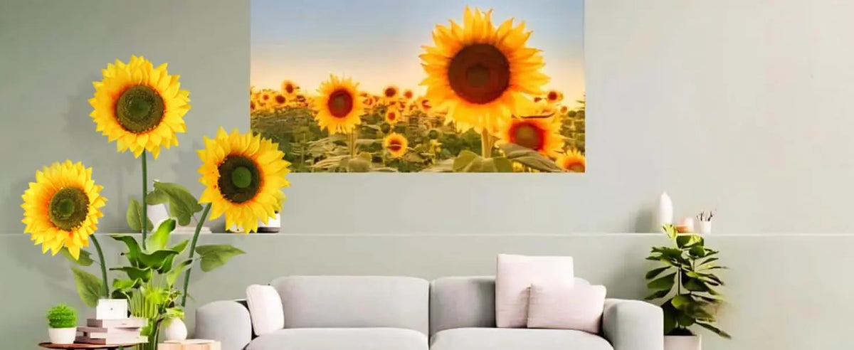 A vibrant painting of a field of sunflowers displayed above a light green wall.