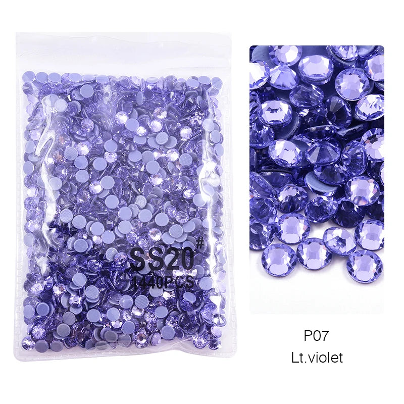 Bag of violet glass rhinestones with various crystal sizes and shapes