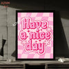A pink and white checkered background with the text Have a nice day in pink script on a framed print.