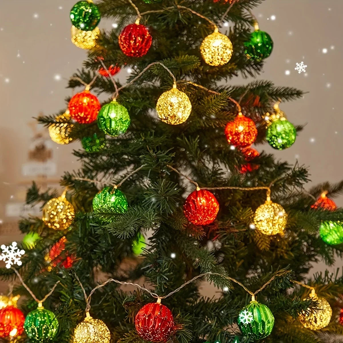A decorated Christmas tree adorned with various colored ornaments and fairy lights.