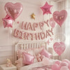 Pink marble birthday balloon decoration set featuring a banner and balloons above a white bed.