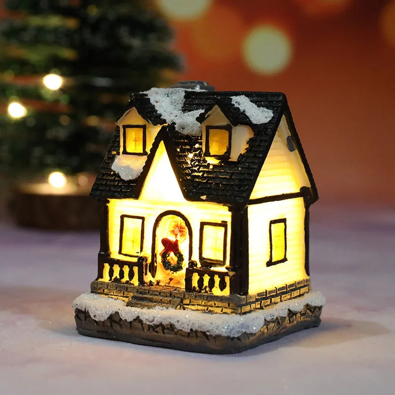 A decorative Christmas house night light featuring a warm LED glow and snow on the roof.