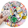 A hand holds a circular arrangement of funny meme graffiti stickers for laptops and other items.