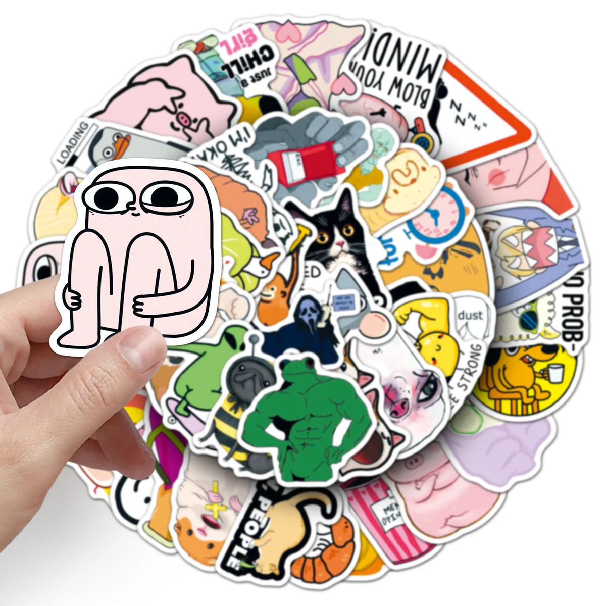 A hand holds a circular arrangement of funny meme graffiti stickers for laptops and other items.